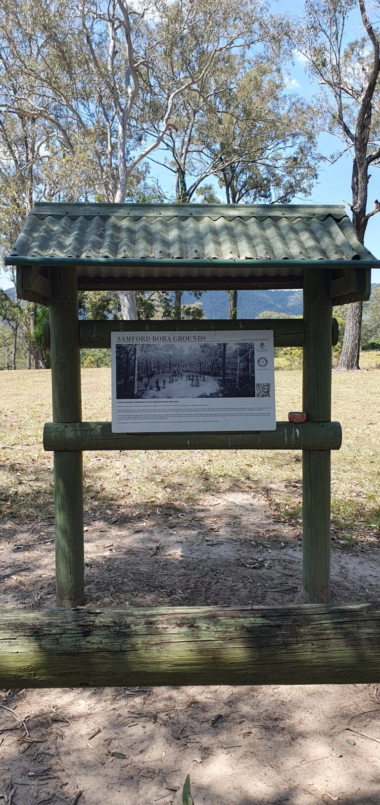 a sign on a wooden structure With information on the aboriginal Bora Ring site