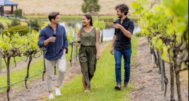 3 people walking through the ocean View vineyard